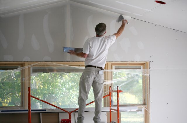 a man repairing a drywall