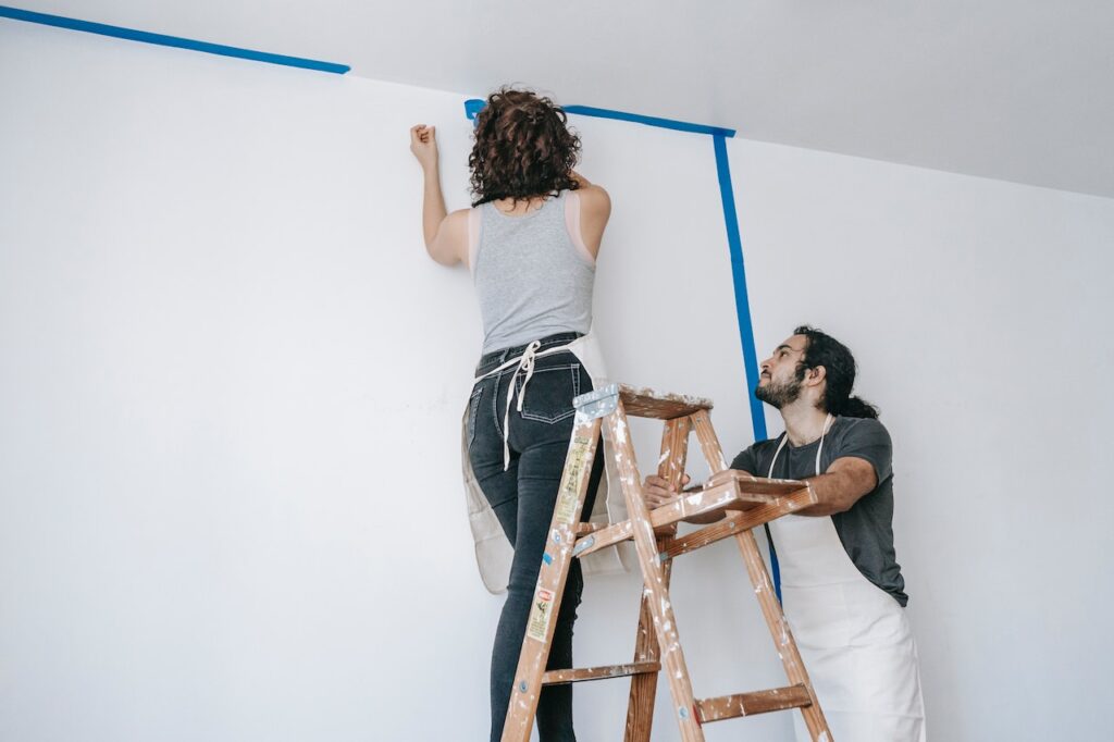 a man and a women repair drywall